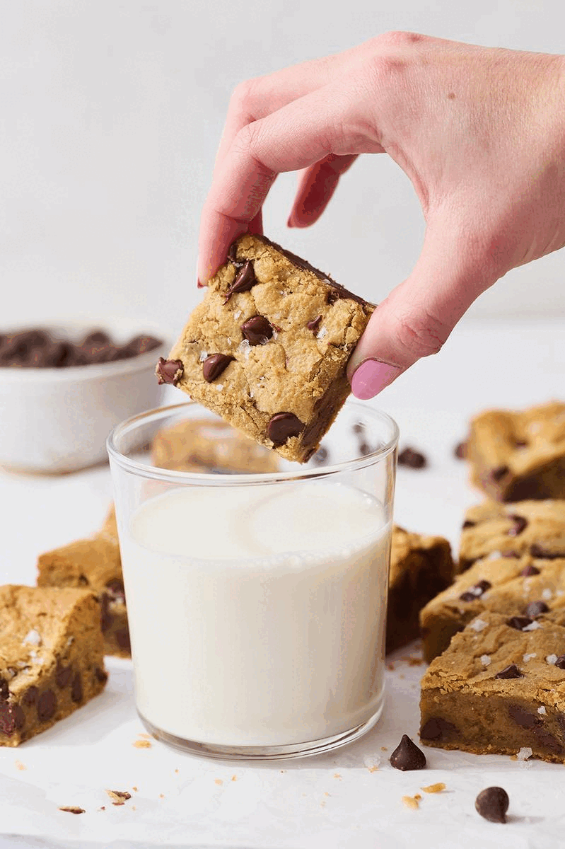 gif of a slice of blondie being dunked in a glass of milk.