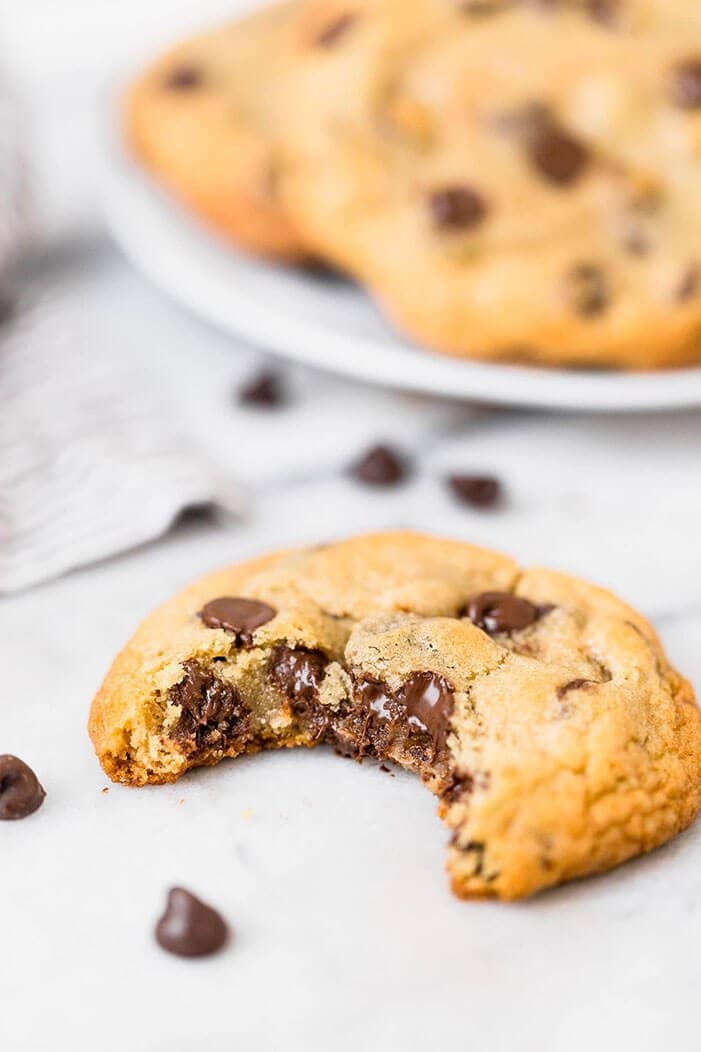 a chocolate chip cookie with a bite taken out.