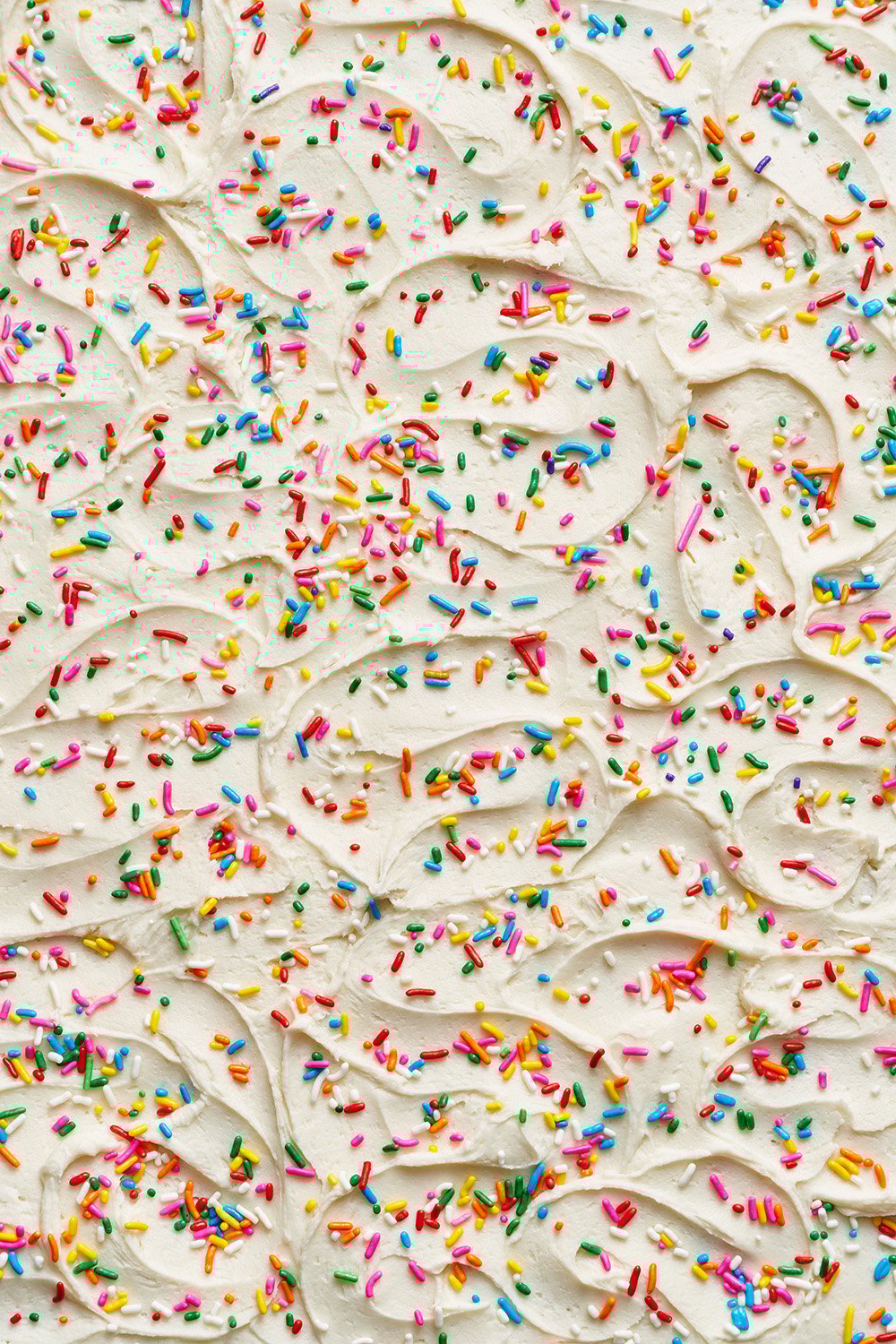 cream cheese frosting swirls with sprinkles.