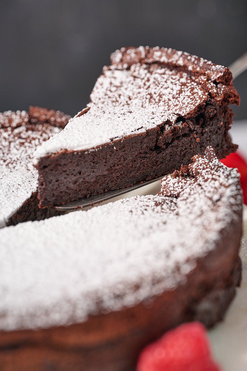 a slice of flourless chocolate cake being served. 
