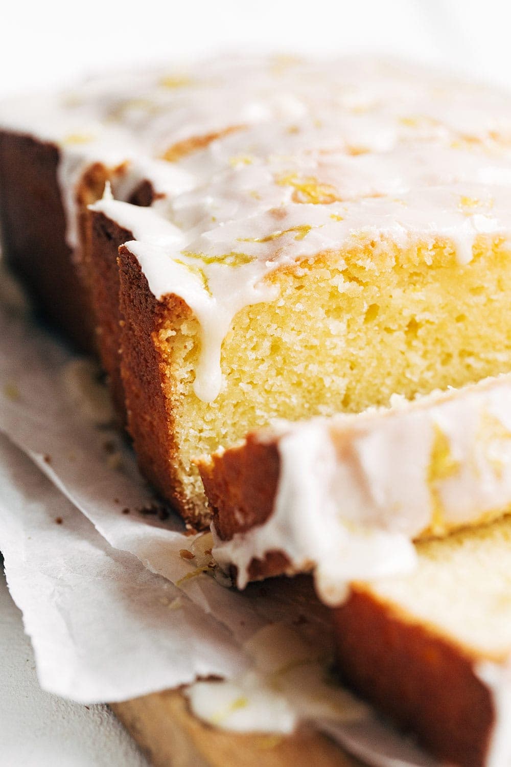 close up of copycat starbucks lemon pound cake with icing dripping.