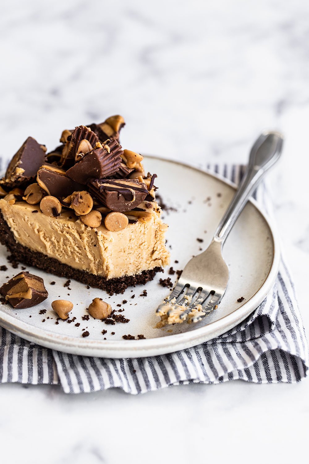 Slice of pie with a fork on a plate.