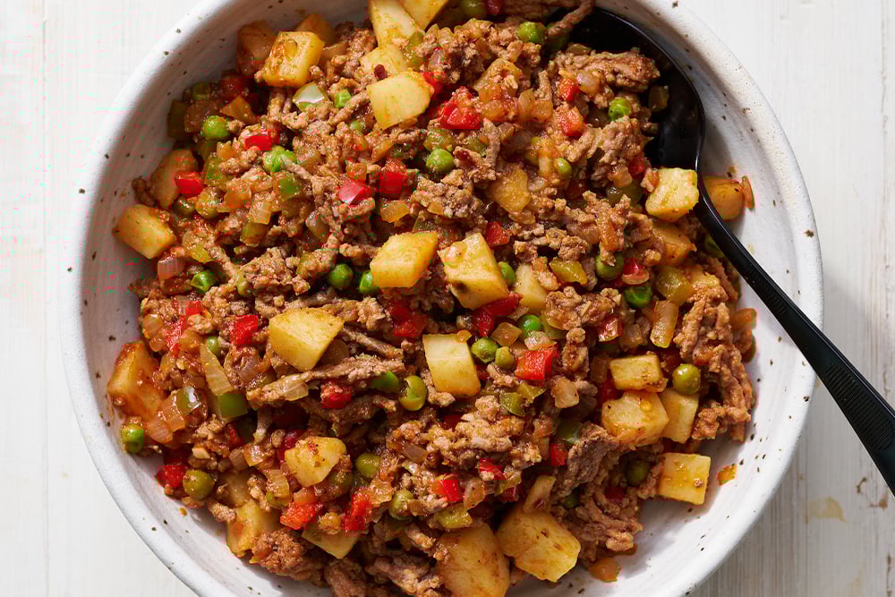 easy beef filling with veggies in a bowl with a spoon. 