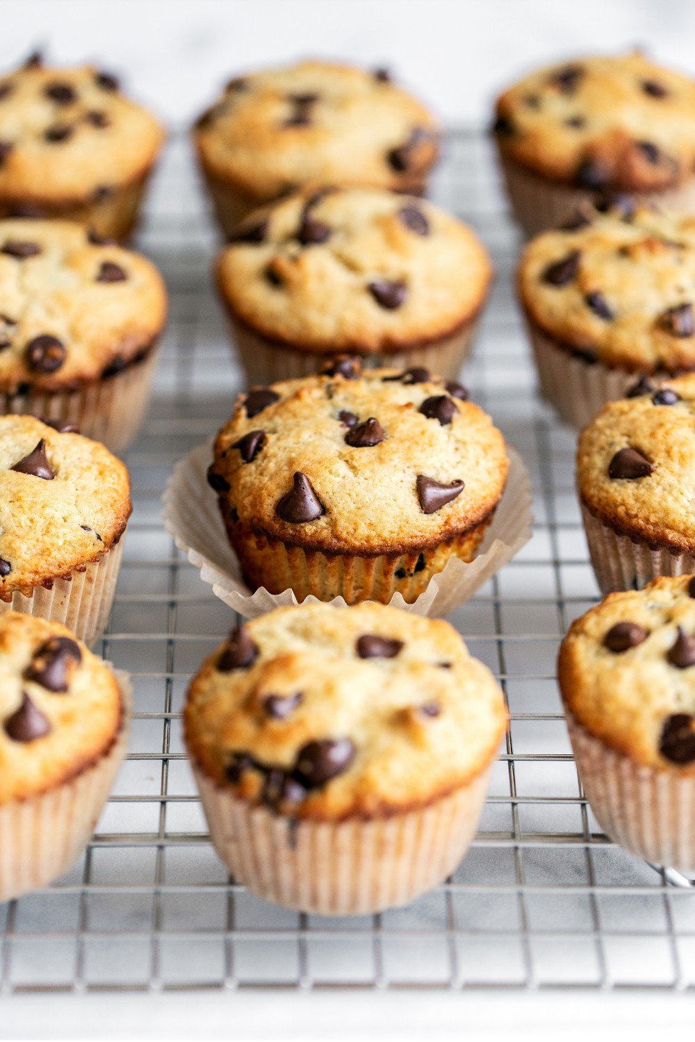 several muffins on a wire rack to cool.