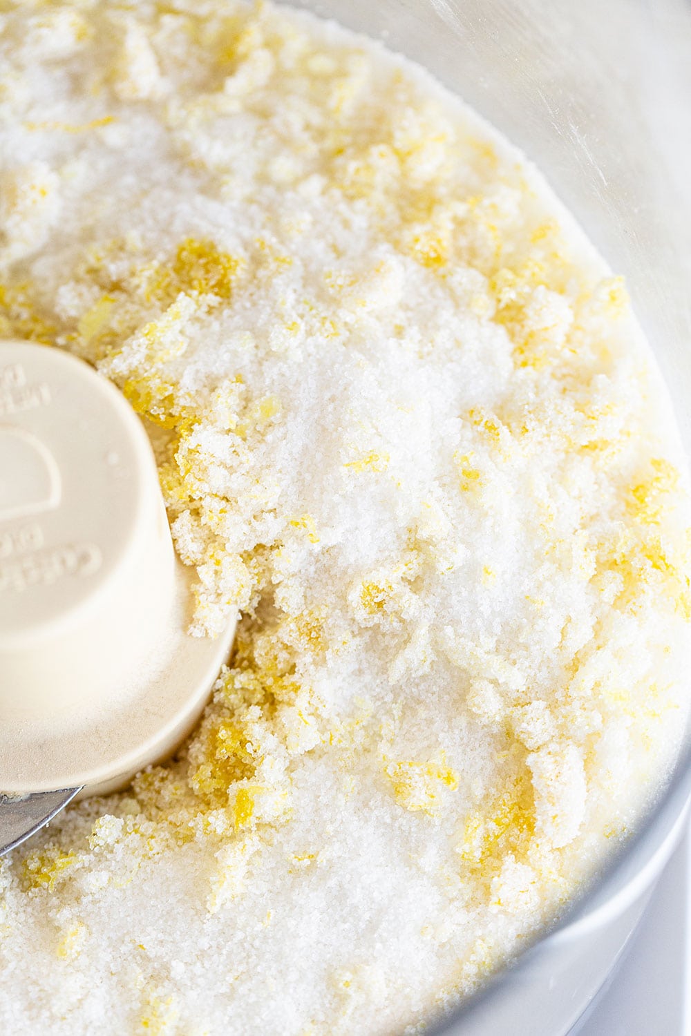 sugar and lemon zest in the bowl of a food processor.